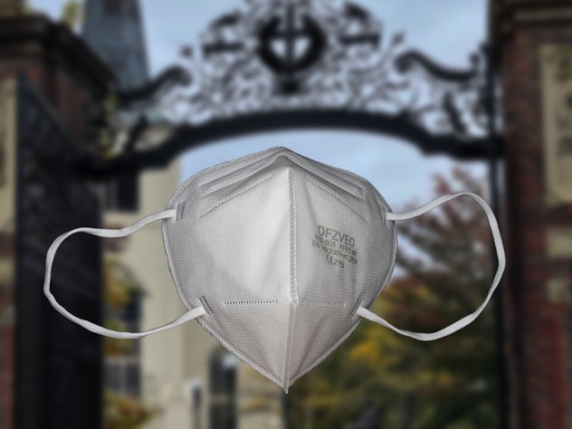 n95 mask in the foreground, Harvard Yard in the background