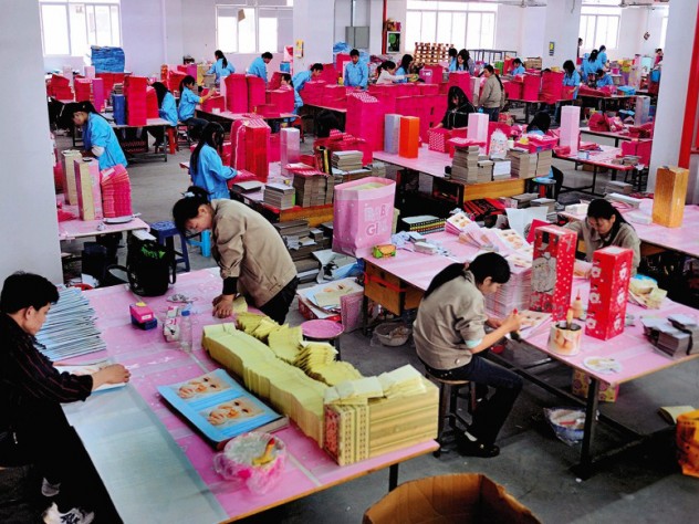 Shenzhen: leased migrant workers (in blue clothes) at a paper factory in the booming southern Special Economic Zone 