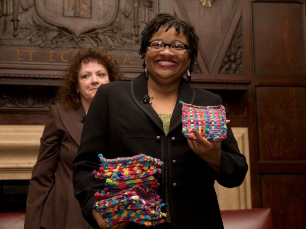 Beverly McIver with potholders made by her sister, Renée, at the Harvard Club of New York event. Filmmaker Jeanne Jordan is in the background.