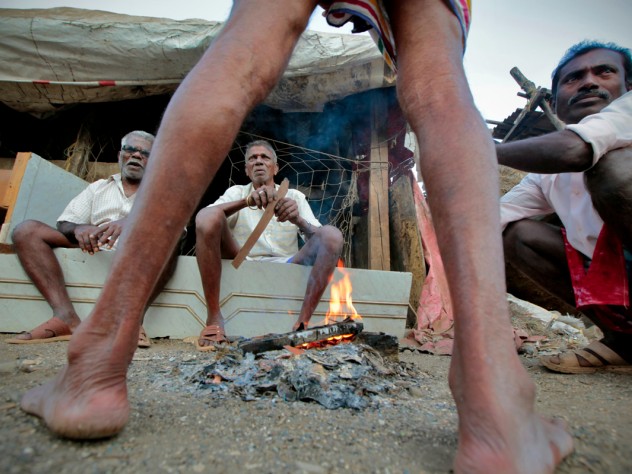 Photograph by Peter Pereira Fishermen prepare to cook lunch. Most head out early, and finish their day's work by 8 a.m.