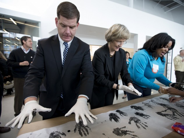 Photograph by Rose Lincoln/Harvard Public Affairs and Communications Harvard University president Drew Faust and Boston mayor Martin J. Walsh participate in a community art project at the opening of the Ed Portal’s new building in Allston.