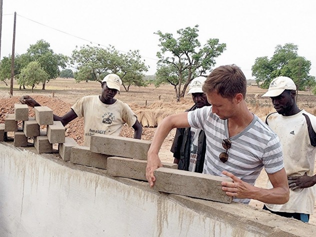 Photograph courtesy of Jordan MacTavish Jordan MacTavish, M.Arch. ’12, demonstrates how the Sinthian Cultural Center's patterned brickwork will allow for ventilation.