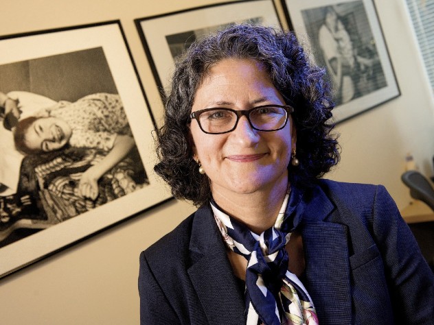 Photograph by Jim Harrison Pediatric palliative-care specialist Joanne Wolfe hangs pictures of patients in her office.
