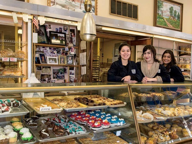 Alejandra Ramirez, Olivia Hitchens, and Gabriela Ramirez (from left to right) preside over the goods at Antoine’s Pastry Shop in Newton.
