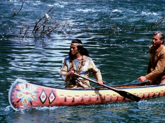 Movie still showing Winnetou and Old Shatterhand paddling a canoe