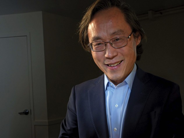 Frank Hu holds a plate filled with food.