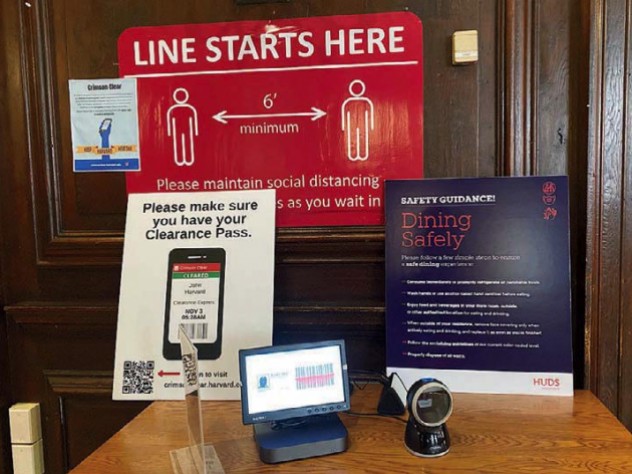 Photograph of posters displaying coronavirus rules at the entrance to Adams House dining hall.