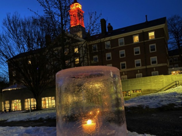 Close-up image of an "ice lantern" (a light set in an ice casing) in the snow on Radcliffe Quad