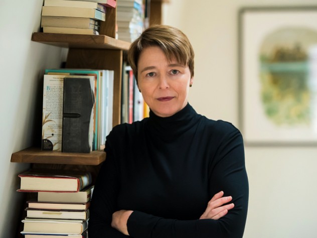 Ophelia Dahl, standing in front of a bookshelf with her arms crossed