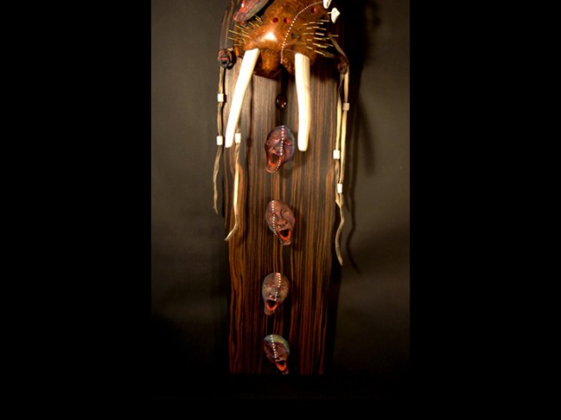 Courtesy of Phillip Charette In Yup’ik lore, the walrus connotes strength. In this dance mask, the smaller mask over one eye represents the walrus’s <em>yua,</em> or spirit. The other spirit masks and the lines of white dots represent ancestors and descendants, the family bloodline. The leather straps hanging down would attach the mask to the wearer’s head.