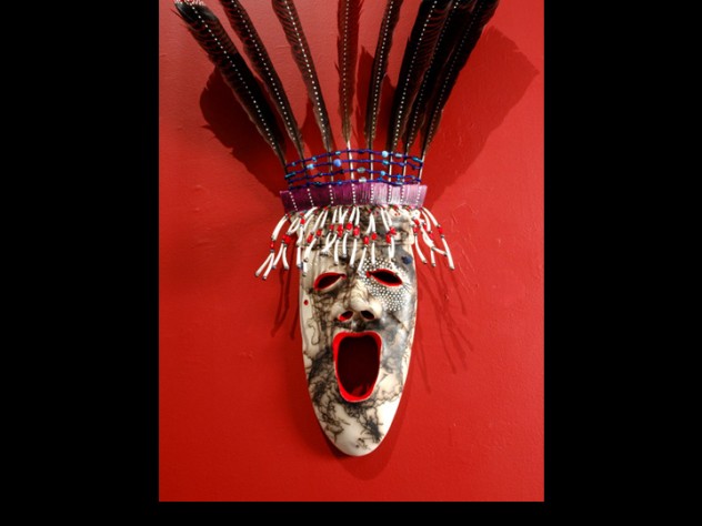 Courtesy of Stonington Gallery The <em>Arctic Dancer</em> mask demonstrates Charette's "horsehair firing" technique, which entails heating clay to 1,800 degrees Fahrenheit and dropping individual hairs onto it to produce a streaked effect. White "stars" around one eye represent a connection to the spirit world; below the other eye is a mole. Yup'ik lore holds that people with a mole near the eye are endowed with spiritual vision; Charette has a mole in the same spot, and uses the mark in his art as a signature.