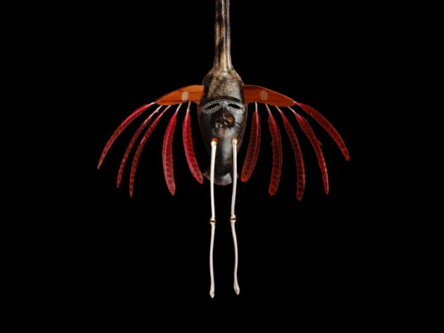 The crane is a meaningful animal in Yup'ik lore and for Charette personally (see first image in this slide show). This four-foot-tall mask, from an Oregon art gallery, features a full crane face and head on top, and a human-like face on the animal's body to represent its <em>yua</em>. This mask, from Charette's <em>Transformation</em> series, is made of horsehair-fired clay, with porcelain "bone" legs and wild-turkey feathers in place of the raptor features used in Yup'ik masks of old.