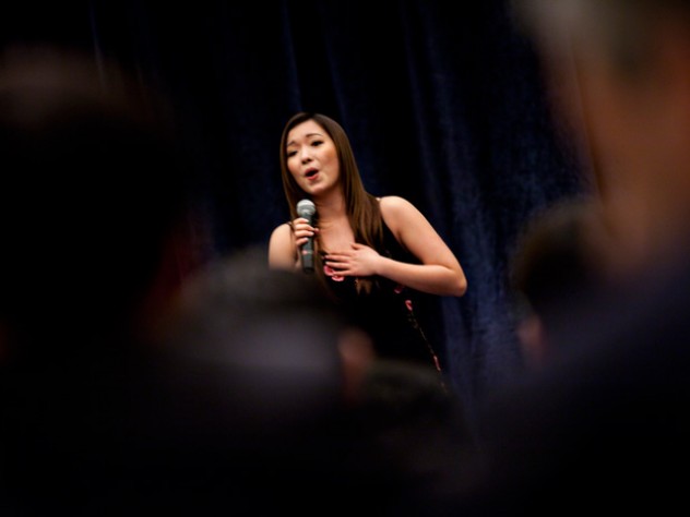 Photograph by Stephanie Mitchell/Harvard News Office Wenqian (“Wendy”) Wang ’10, who interned in Beijing last summer, closes the March 18 banquet with a rousing version of <i>“Wo ai ni Zhongguo”</i> (“I Love You, China”).