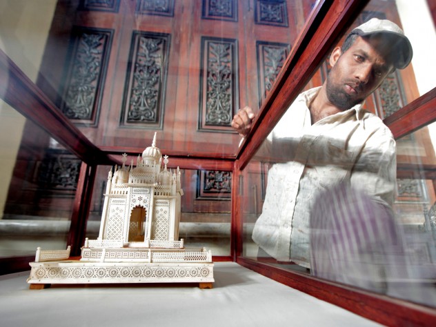 Photograph by Peter Pereira It was important to Princess Esra that the restored palace tell the story of the Asaf Jah dynasty. Here, a worker cleans a historical display.
