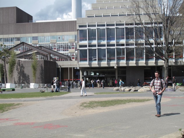 Photograph by Harvard Magazine/JC 6. Preconstruction: the main pedestrian crossroads, seen from Harvard Yard looking north toward the main mass of the Science Center; the bamboo planters then in place, to the left, will be replaced with a much larger, continuous, permanent planting of mixed species, to form a shaded grove.
