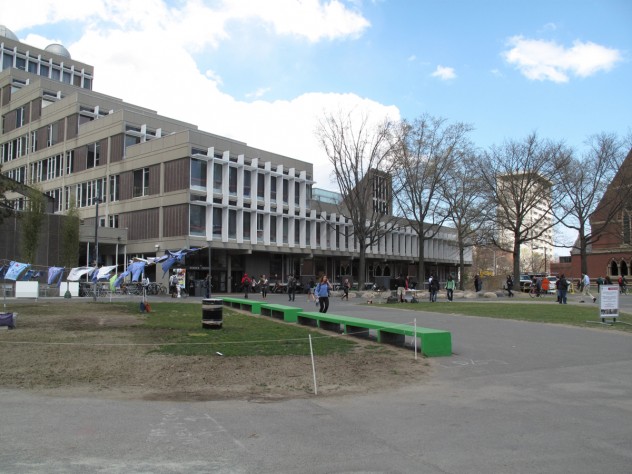 Photograph by Harvard Magazine/JC 11. The Science Center; the rocks at the base of the trees are part of the Tanner Fountain, which is to be repaired and restored.