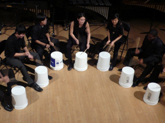 Courtesy of Hanna Choi The ensemble's trademark is using offbeat objects, such as stools and buckets, as well as traditional percussion instruments.