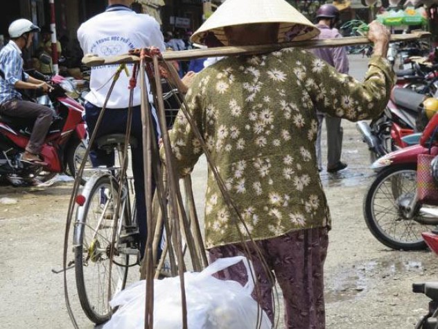 Photograph by Susan Bennett For all its gains during the past 25 years, much of Vietnam’s economy remains traditional, as in My Tho’s market street (shown here) and outside the major cities.