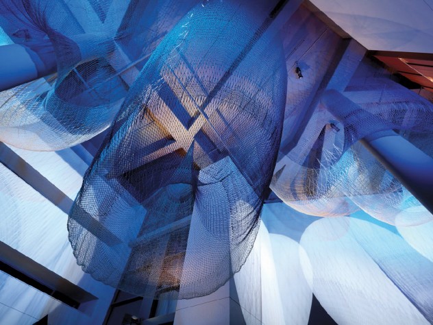 Photograph by Ema Peter/Courtesy of Janet Echelman <i>Allegory,</i> another 2014 work, hangs in the University of Oregon’s basketball arena. Its five distinct forms are meant to suggest the teamwork between players on the court.