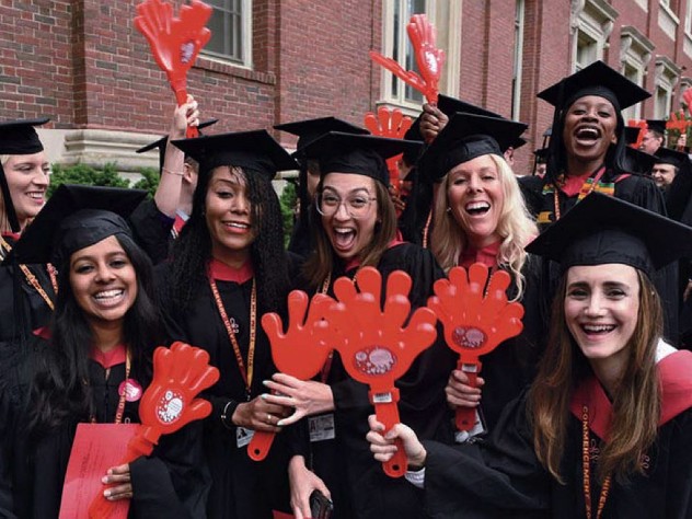 Harvard students in caps and gowns enjoying Commencement
