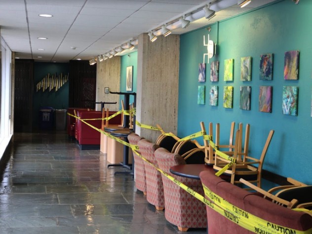 A hallway in Quincy House, with chairs cordoned off limits against the wall