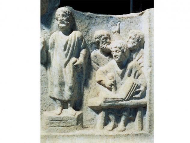 Photograph of a carved relief showing orator dictating to a scribe, from the fourth-century Roman Temple of Hercules at Ostia Antica
