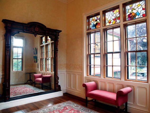 Highfield Hall’s large wall mirror, stained glass, and other architectural details