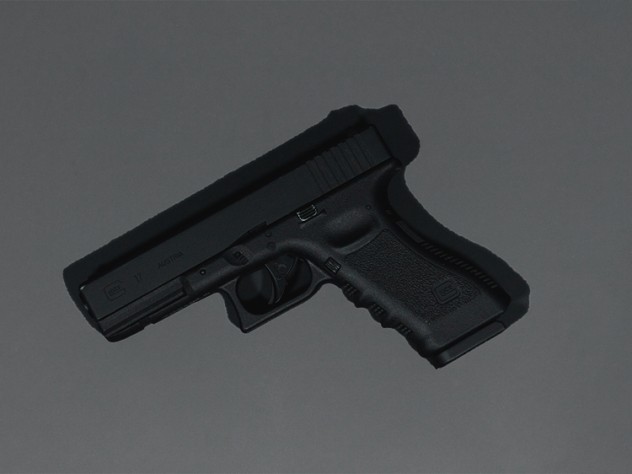 black semi automatic pistol on gray surface