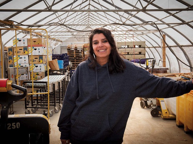 Usha Thakrar standing in the greenhouse production center at Stonefield Farm