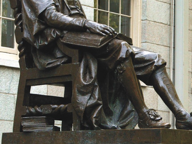 The John Harvard statue, with books at hand
