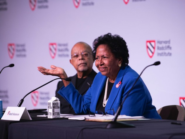Ruth Simmons sits at a table on the stage with Henry Louis Gates, Jr.