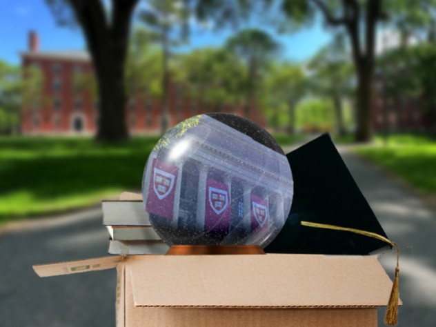 Moving out box in Harvard Yard with a Harvard snow globe, graduation cap, and books