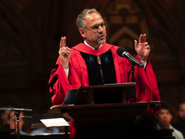 Adam Falk delivering his talk in academic robes