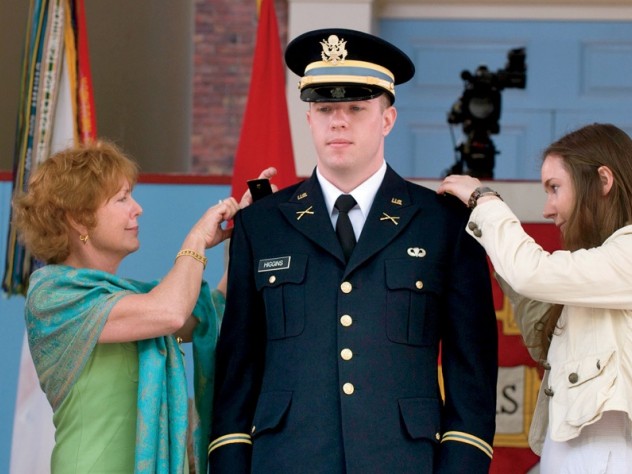 Photograph by Jim Harrison New second lieutenant Christopher Higgins ’11 has his bars pinned on by his mother and sister.