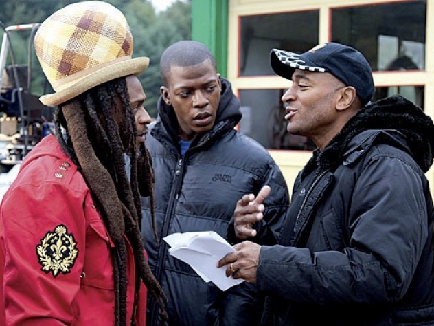 Khan advising Rastafarian musician David Hinds and Sanders 