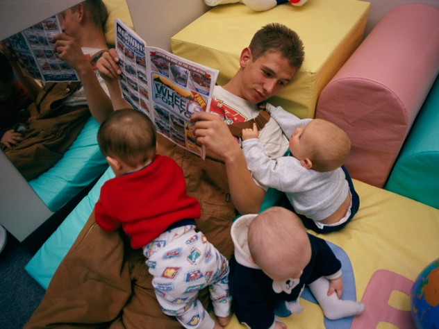 This teenager regularly hurries from  his job to a local day-care center to  spend time with his son in his new role  as a father.