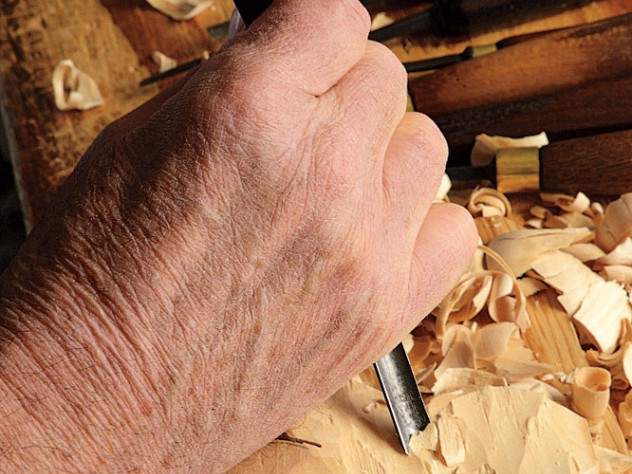 Esterly attacking limewood with the two-fisted technique of woodcarving