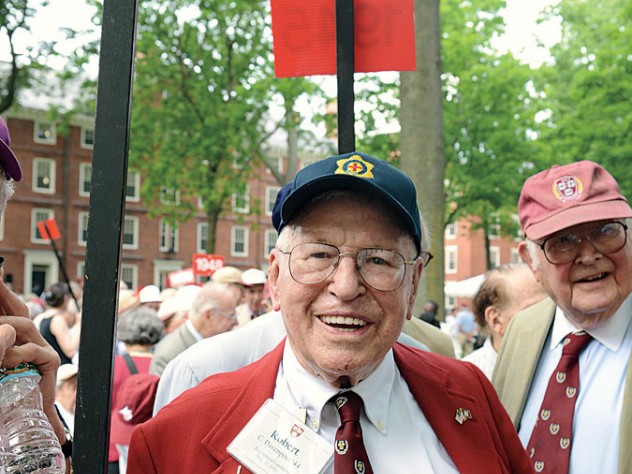Major General Robert C. Davenport (Massachusetts Army National Guard, retired) hoists his class&rsquo;s placard on Commencement afternoon. Secretary Fenn is at right.