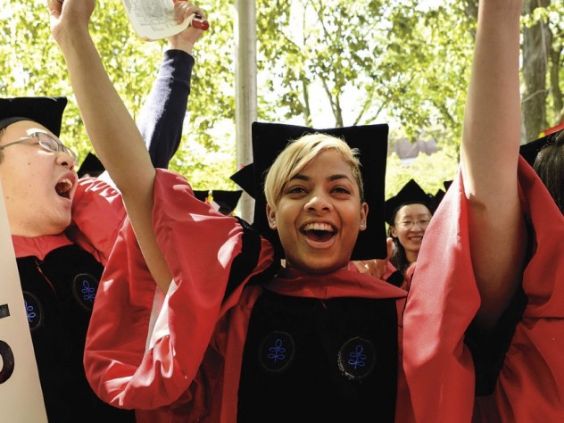 Photograph by Stu Rosner Displaying Ph.D.-powered pride are crimson-gowned Jin Cheng “George” Ye, Anouska Bhattacharyya, and Cammi Valdez.