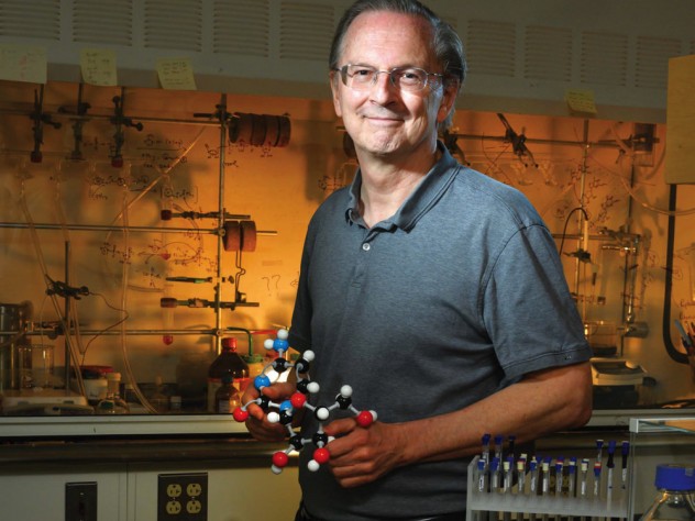 Jack Szostak, in his lab at Massachusetts General Hospital, holds a model of a nucleic acid.