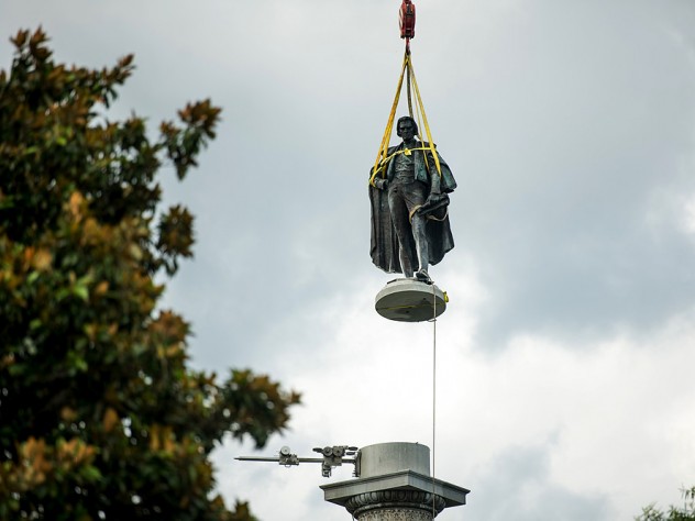Photograph of John C. Calhoun statue in Charleston in midair being lifted up by a crane