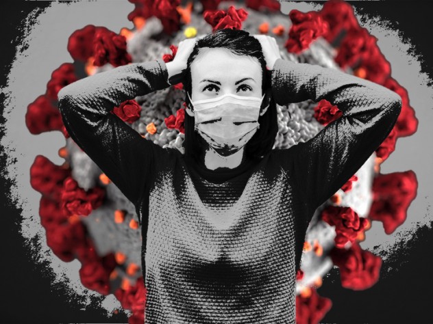 A person wearing a mask standing in front of the COVID virus