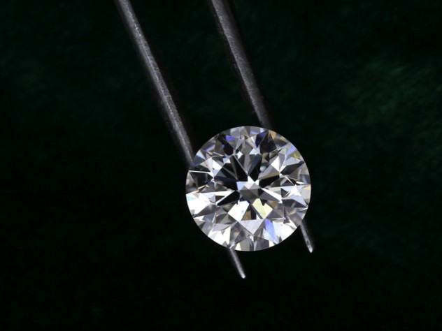 Diamond held by metal tongs