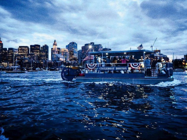 Boat cruising on Boston harbor at twilight