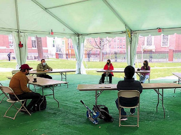 Photograph of teaching a playwriting class under a tent outdoors