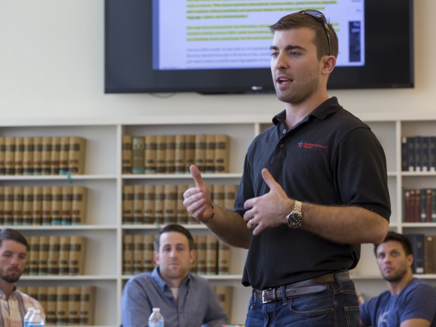 Photograph by Freddie Reed/Courtesy of the Warrior-Scholar Project Program director Logan Leslie ’16, a veteran of the Special Operations Forces and member of the National Guard, leads a seminar during the WSP course. The project, which debuted at Yale University in 2012, expanded to Harvard and the University of Michigan this year.