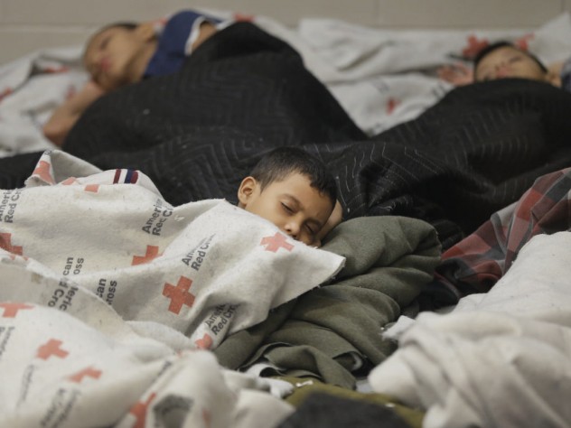 Photograph © Eric Gay/Pool/Corbis Detainees sleep in a holding cell at a U.S. Customs and Border Protection processing facility on Wednesday, June 18, 2014, in Brownsville, Texas. The CPB provided media tours that day of two locations in Brownsville and Nogales, Arizona, that have been central to processing the more than 47,000 unaccompanied children who have entered the country illegally since last October 1.
