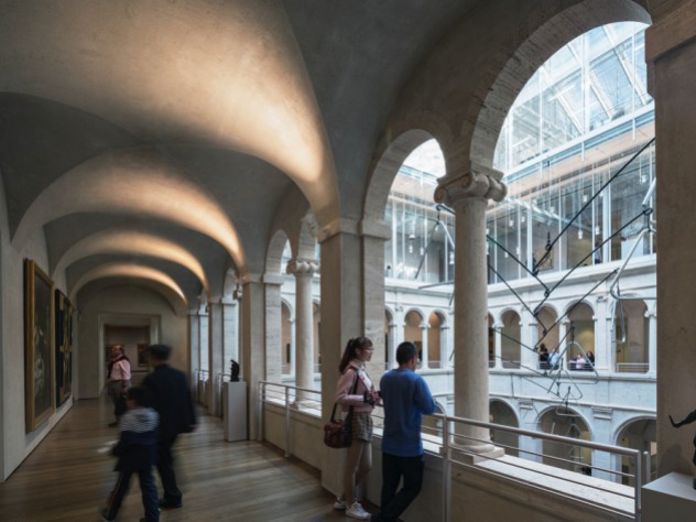 A few visitors in the arcade overlooking the Calderwood Courtyard of the Harvard Art Museums
