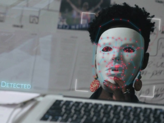 Joy Buolamwini dons a white mask in order to be visible to facial recognition software in the film Coded Bias.
