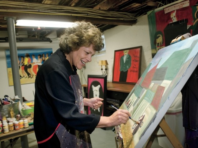 Surrounded by her own works, Langer wields a brush in her home studio.  A self-taught painter who took up the avocation in midlife, she describes her autodidactic approach to art in <em>On Becoming an Artist: Reinventing Yourself Through Mindful Creativity</em> (2005).